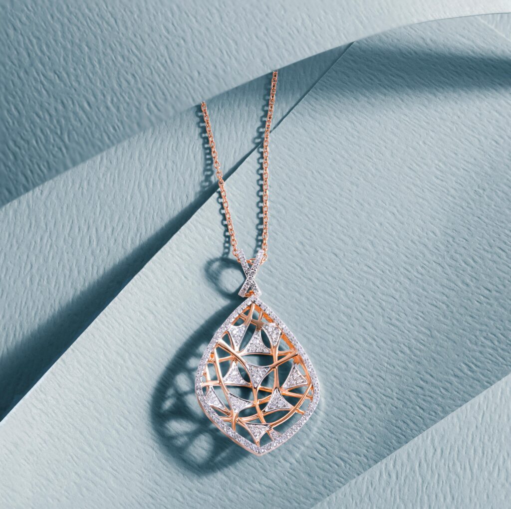 pexels-photo-10983785-10983785 Luxurious diamond pendant with intricate design on a soft blue textured surface, showcasing elegance and craftsmanship.